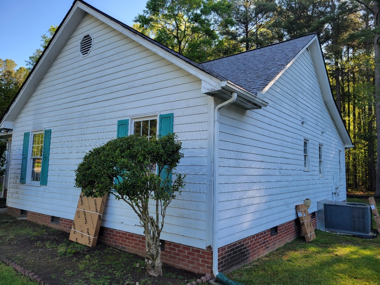 side view of a home before getting new siding and other exterior work done