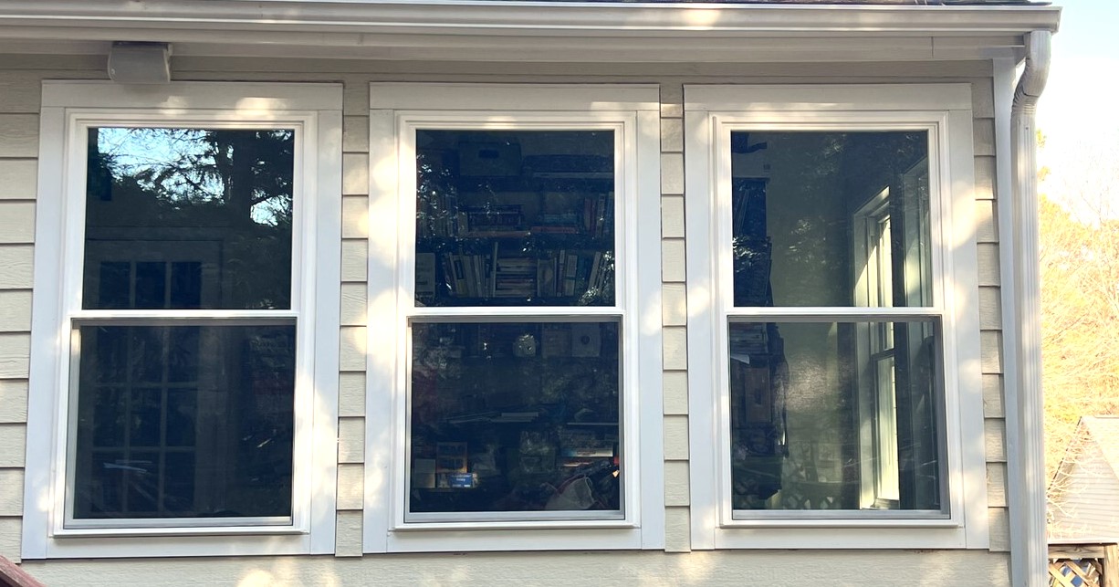 Newly installed windows in Cary, NC on a pale yellow house.