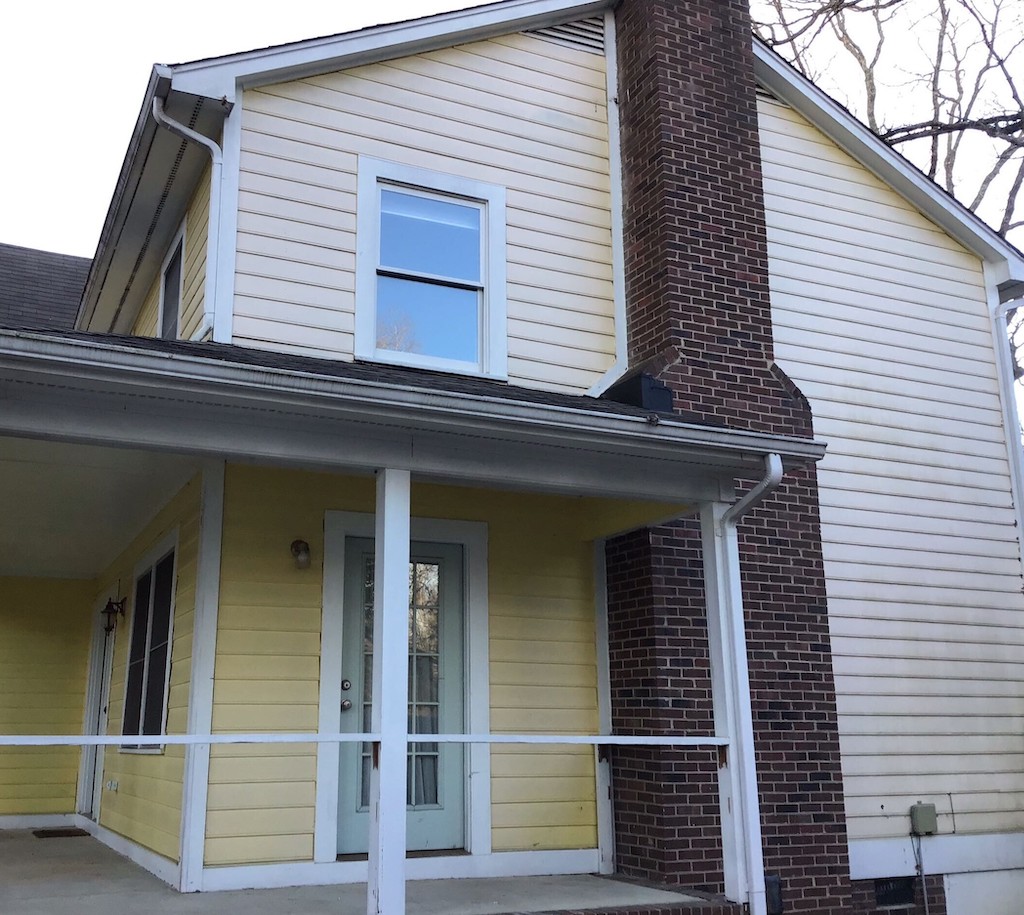 The Maycock home before getting new James Hardie siding and a gutter replacement