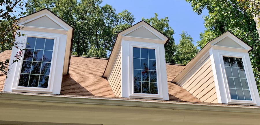 Window replacement in Durham, NC. Three windows poking through a second story sloped roof.